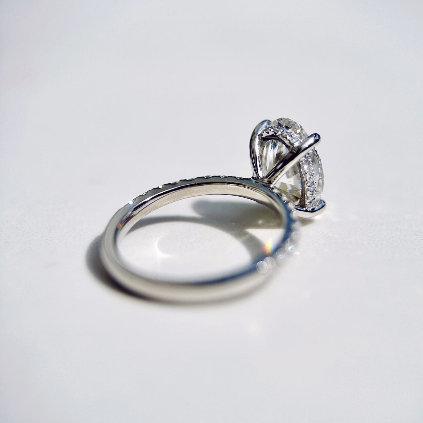 1.80 CT oval cut CVD lab grown diamond engagement ring with hidden halo, pave-set band, E color, VS1 clarity, in white gold setting