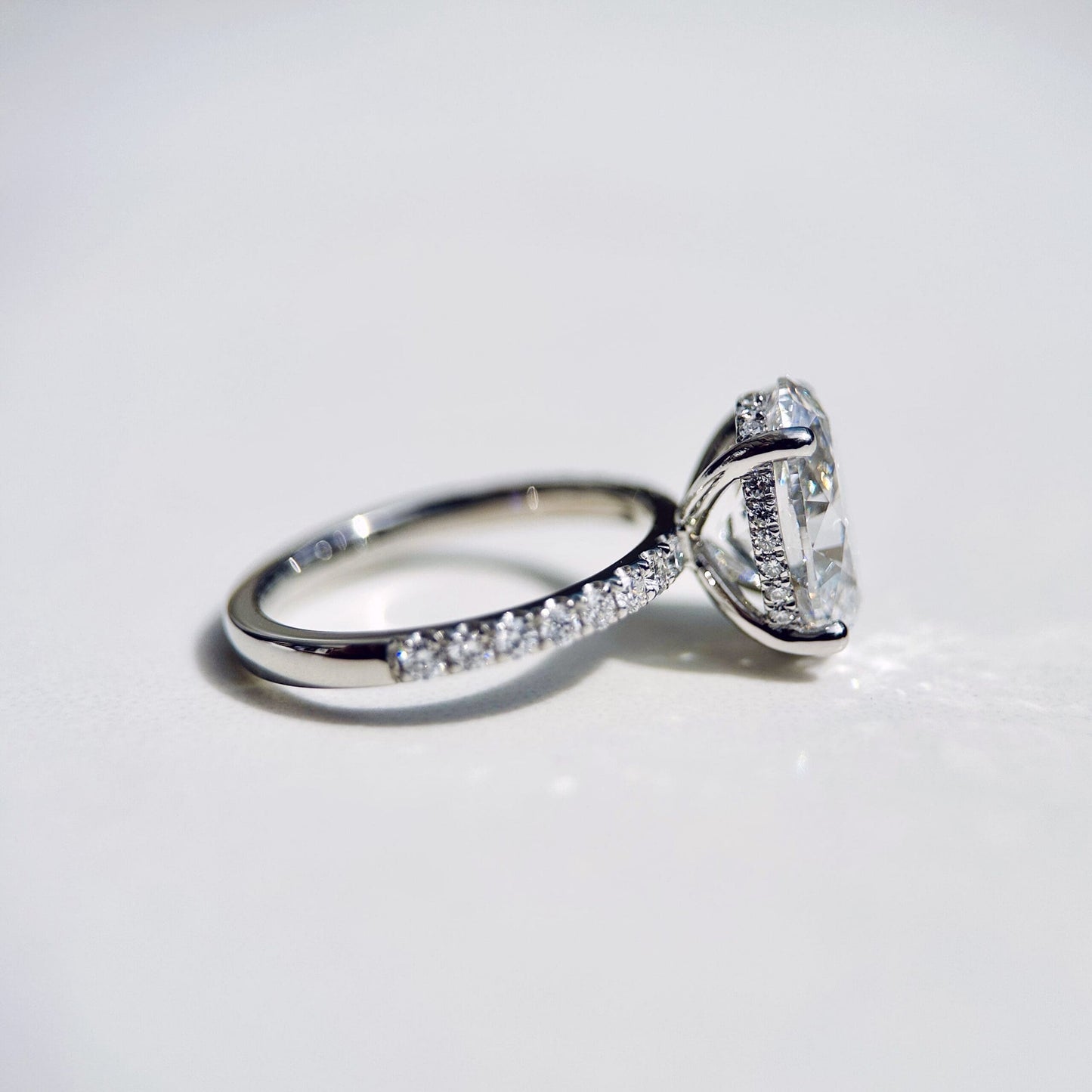 1.80 CT oval cut CVD lab grown diamond engagement ring with hidden halo, pave-set band, E color, VS1 clarity, in white gold setting