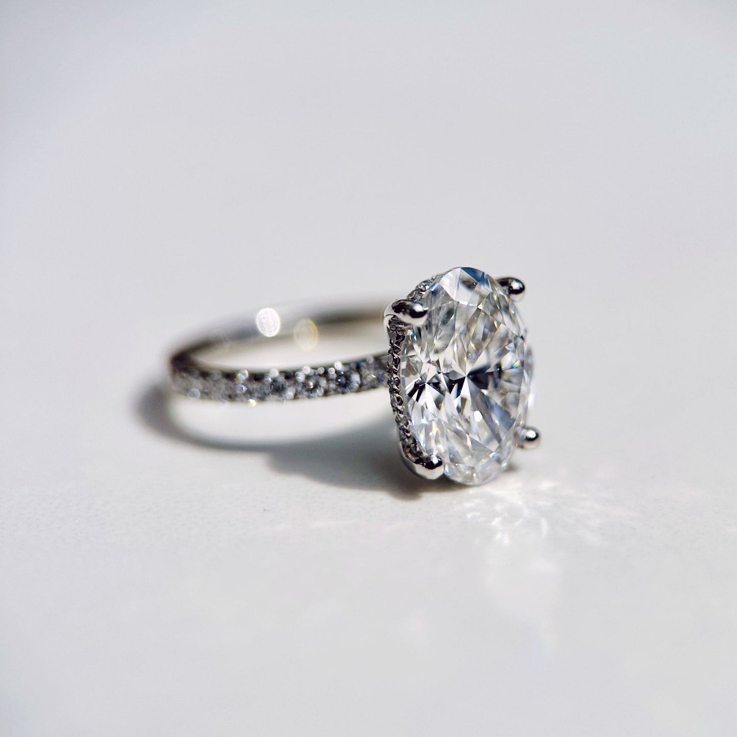 1.80 CT oval cut CVD lab grown diamond engagement ring with hidden halo, pave-set band, E color, VS1 clarity, in white gold setting