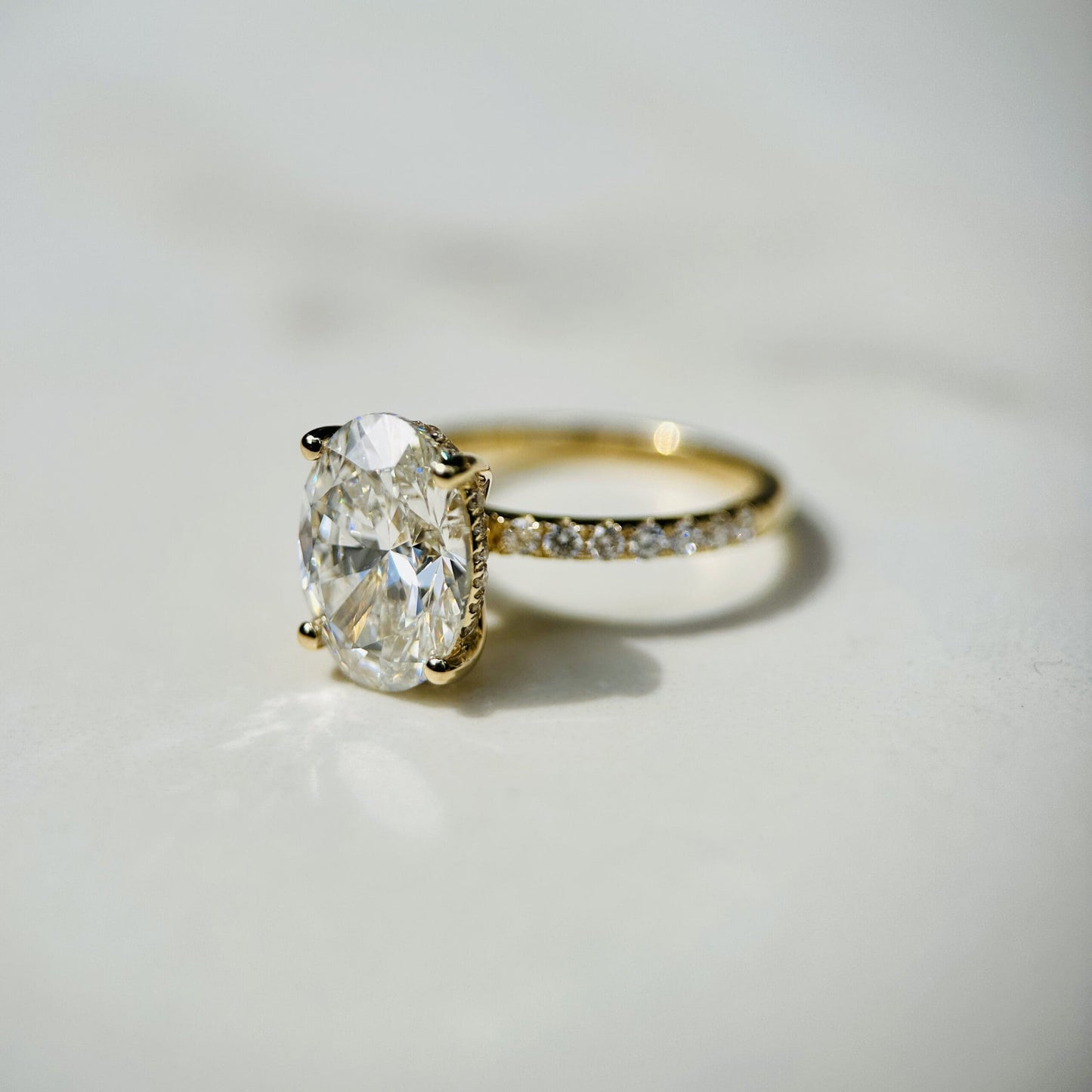 1.80 CT oval cut CVD lab grown diamond engagement ring with hidden halo, pave-set band, E color, VS1 clarity, in white gold setting