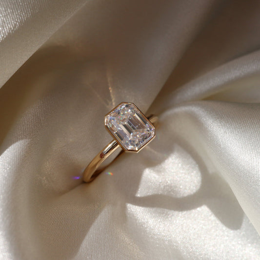 Emerald moissanite bezel set engagement ring