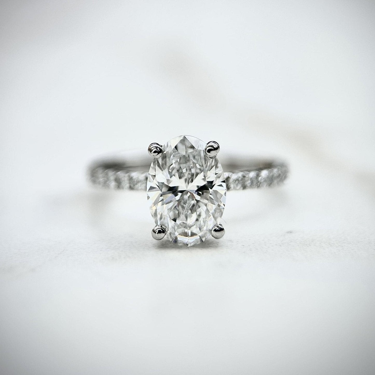 1.80 CT oval cut CVD lab grown diamond engagement ring with hidden halo, pave-set band, E color, VS1 clarity, in white gold setting