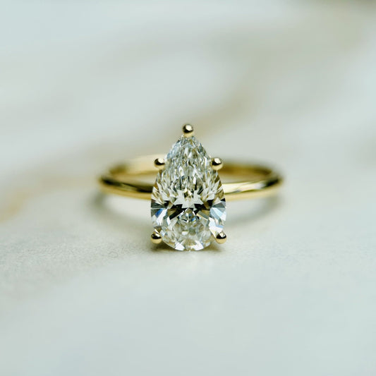 1.50 CT pear cut CVD lab grown diamond solitaire engagement ring with E color, VS1 clarity, set in a classic prong on white gold band