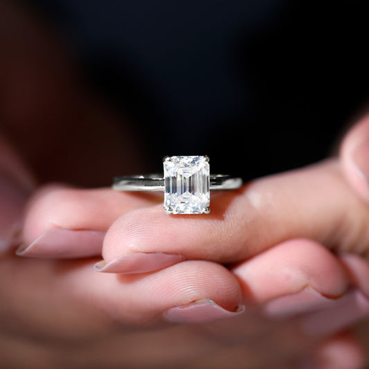 Emerald cut moissanite solitaire engagement ring in elegant setting