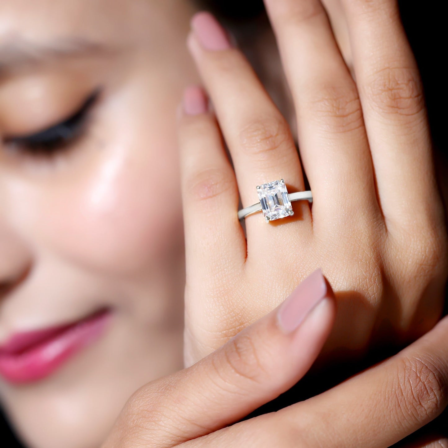Emerald cut moissanite solitaire engagement ring in elegant setting
