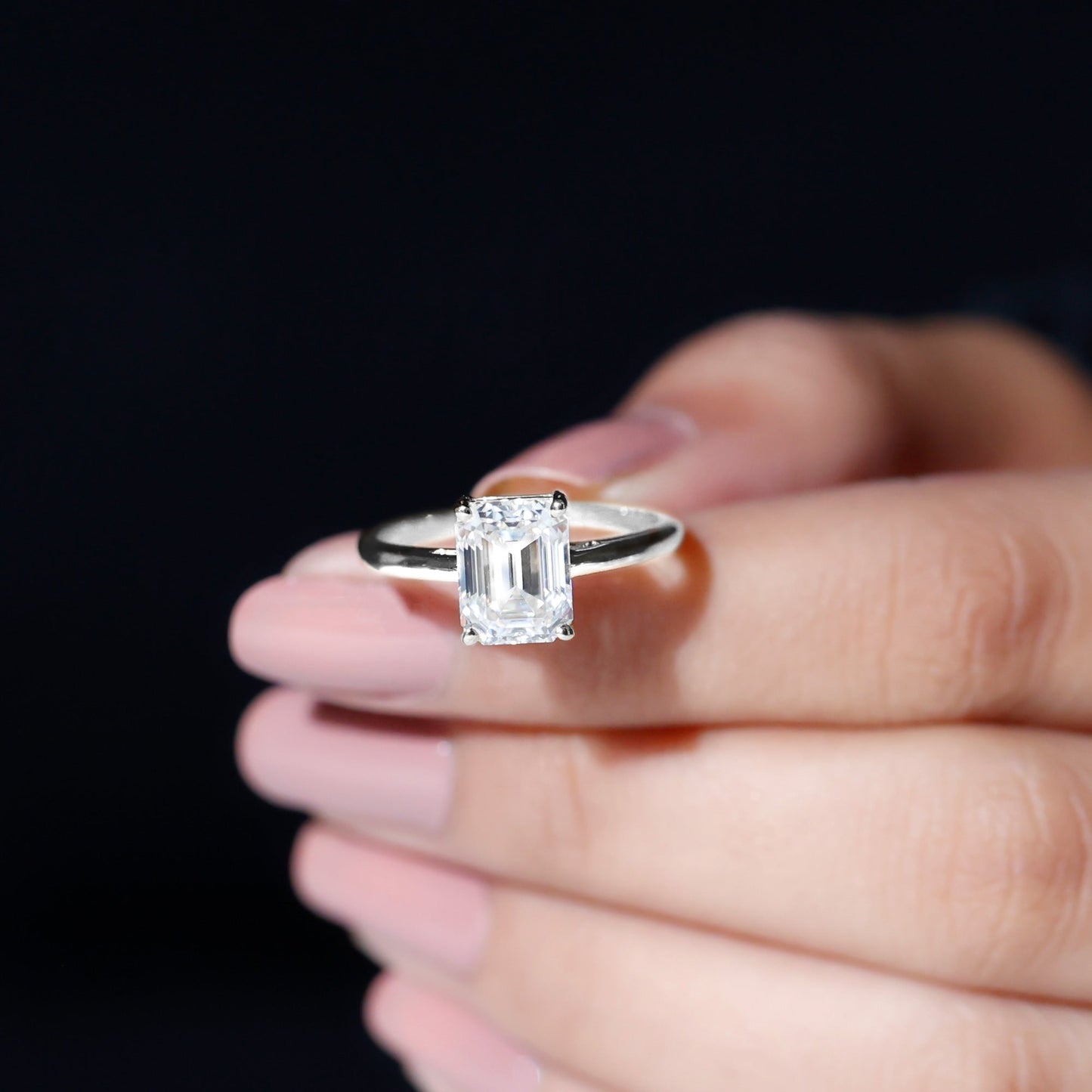 Emerald cut moissanite solitaire engagement ring in elegant setting