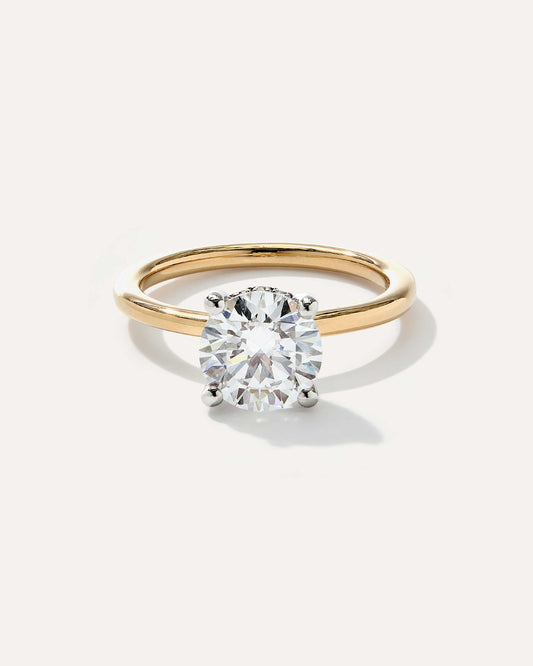 Round cut CVD lab grown diamond hidden halo engagement ring with delicate pave accents and a polished metal band