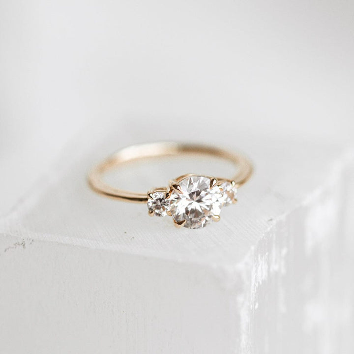 Three stone engagement ring with round cut moissanite