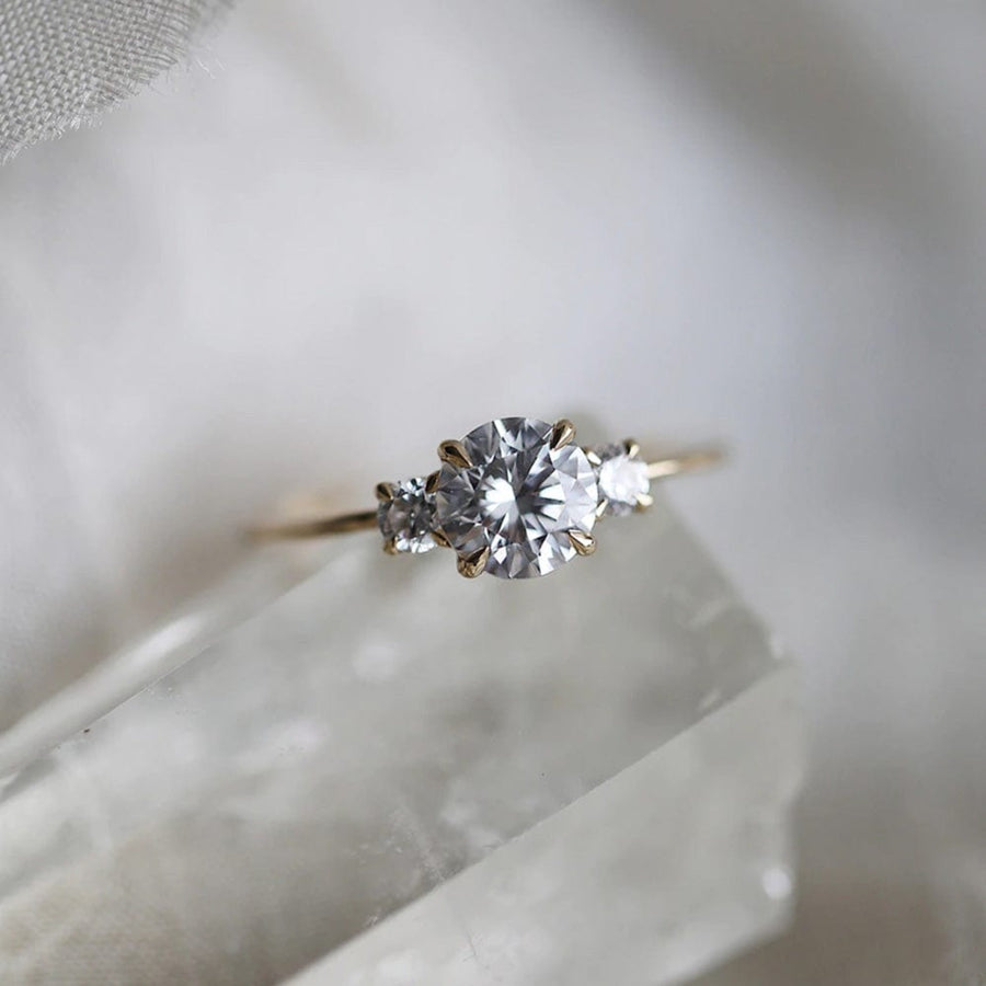 Three stone engagement ring with round cut moissanite
