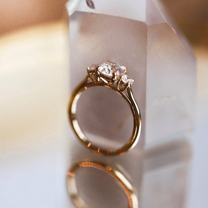 Three stone engagement ring with round cut moissanite