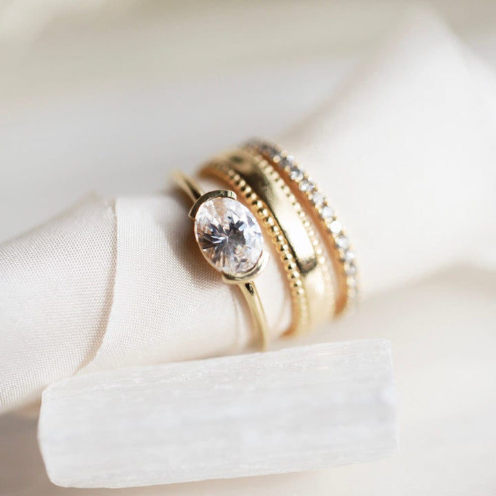Half bezel oval moissanite solitaire engagement ring