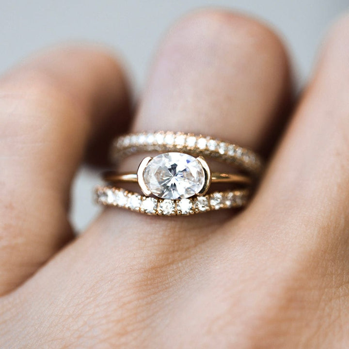 Half bezel oval moissanite solitaire engagement ring