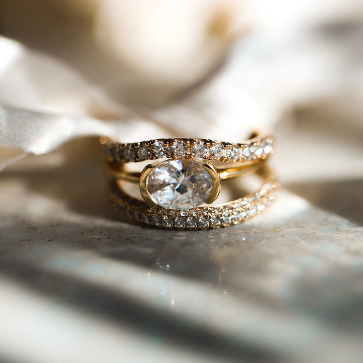Half bezel oval moissanite solitaire engagement ring