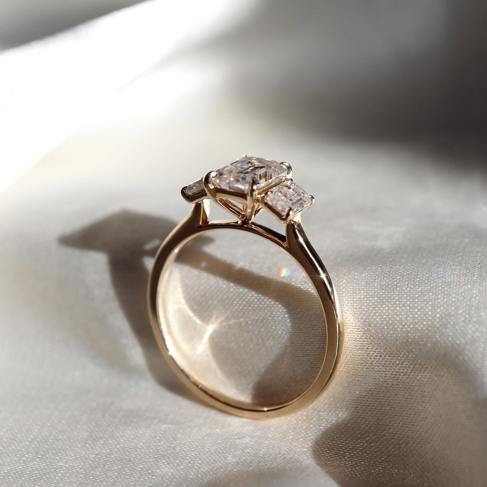 Three stone emerald moissanite engagement ring