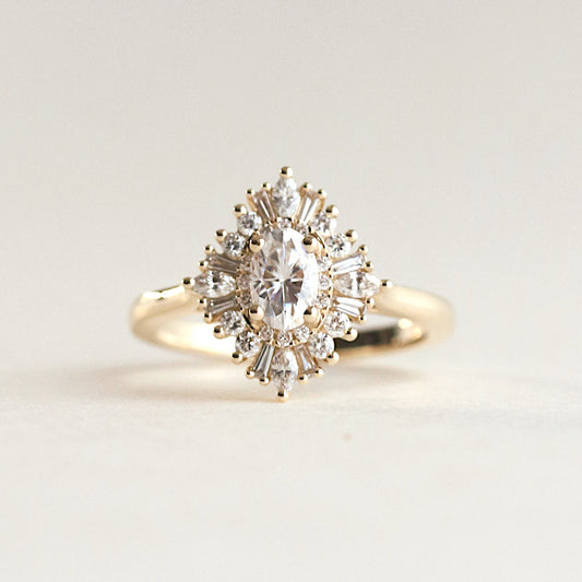 Oval cut CVD lab grown diamond starburst engagement ring with halo of tapered baguette diamonds