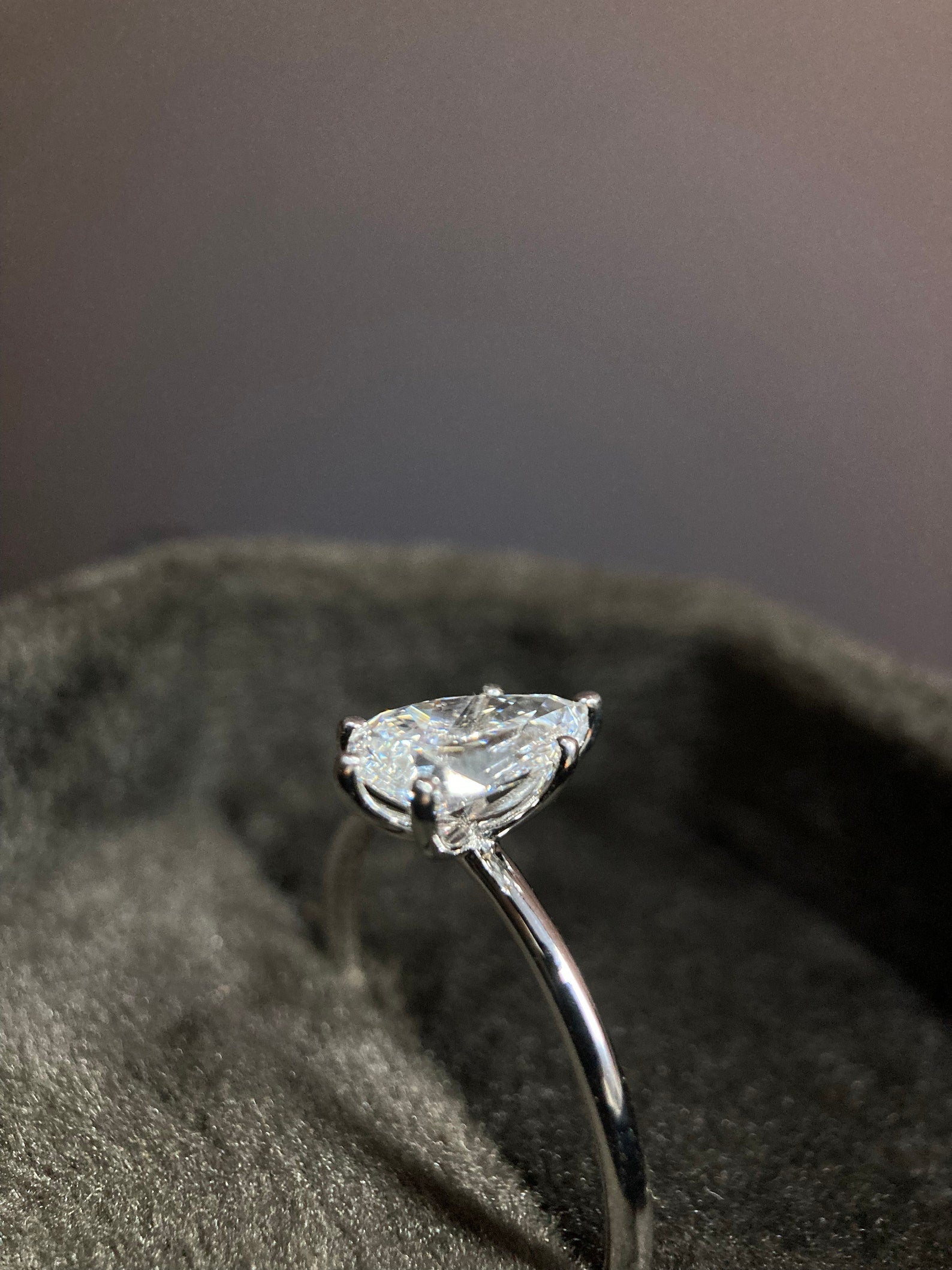 Pear cut moissanite solitaire engagement ring with timeless elegance