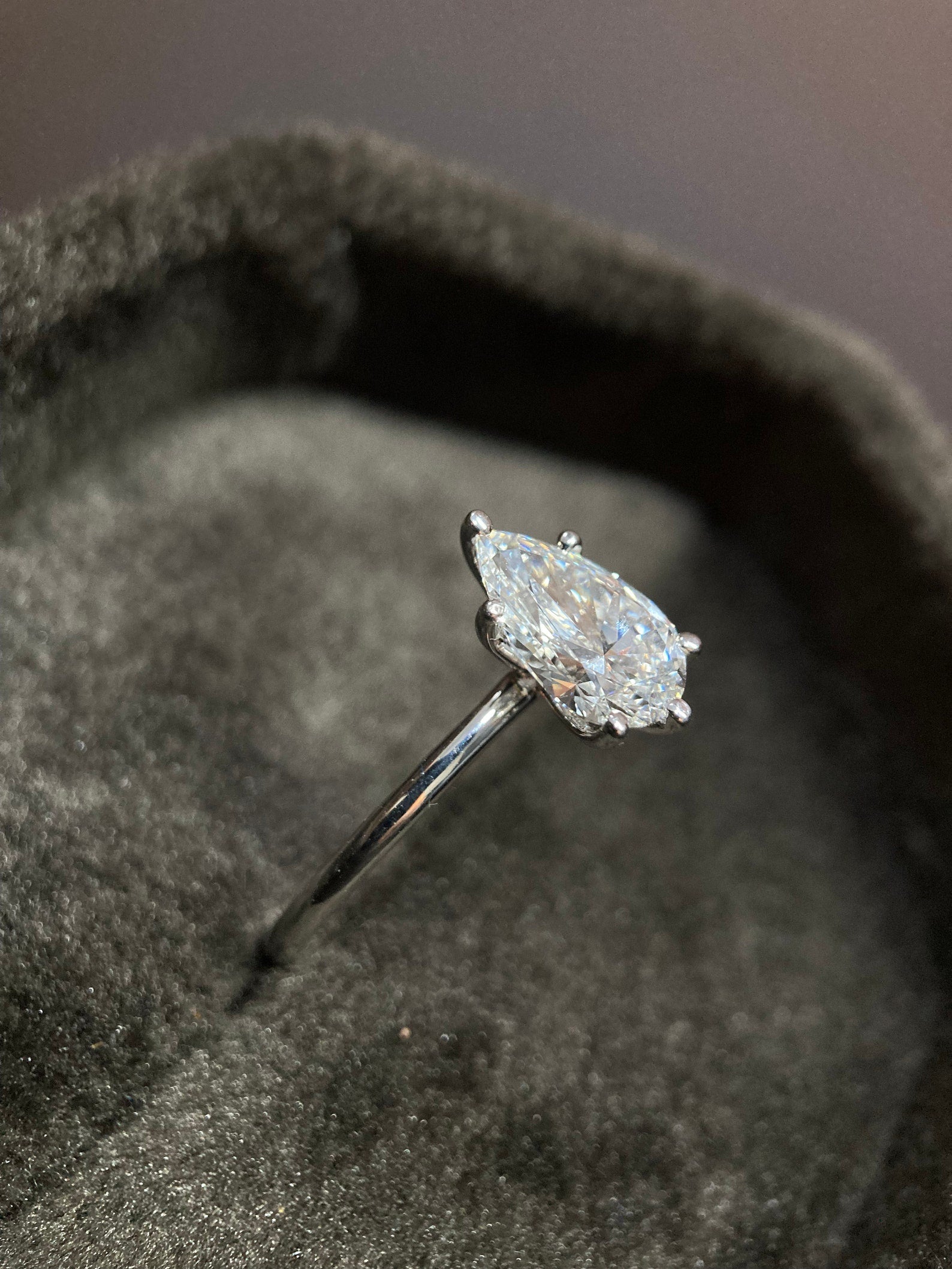 Pear cut moissanite solitaire engagement ring with timeless elegance