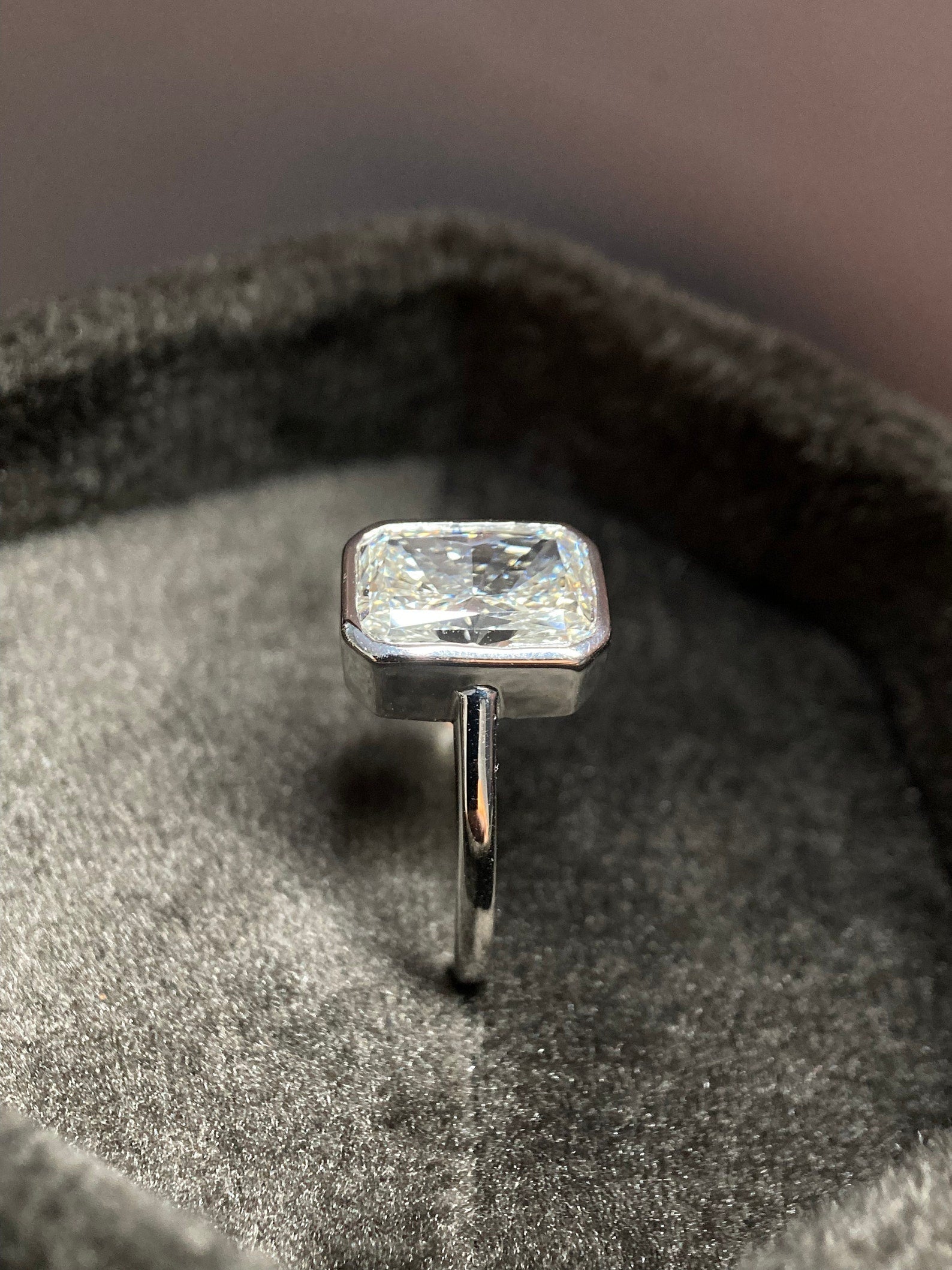 Radiant cut moissanite bezel engagement ring in modern sleek design