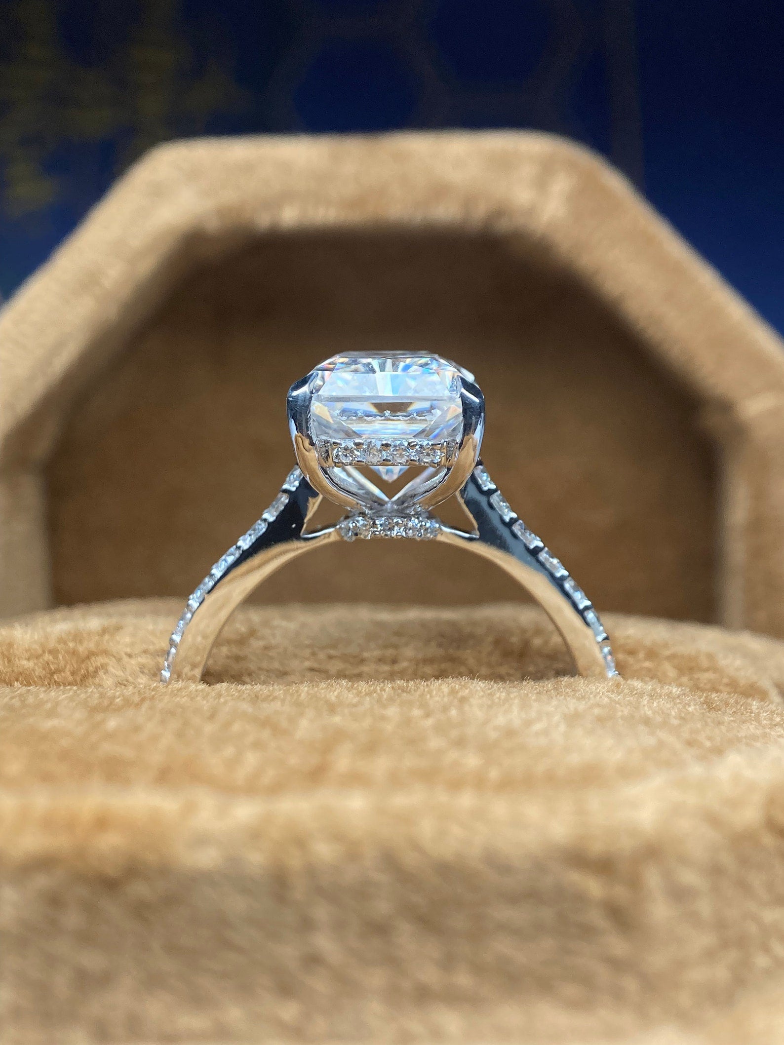Radiant cut moissanite engagement ring with hidden halo design
