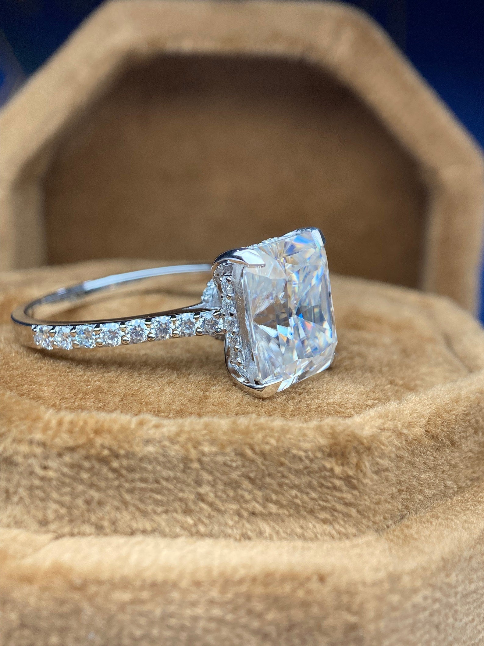 Radiant cut moissanite engagement ring with hidden halo design