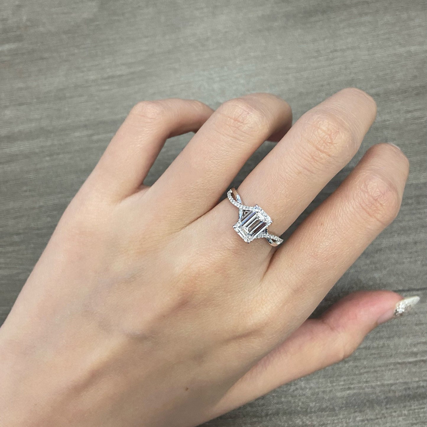 Emerald cut CVD diamond twisted style engagement ring
