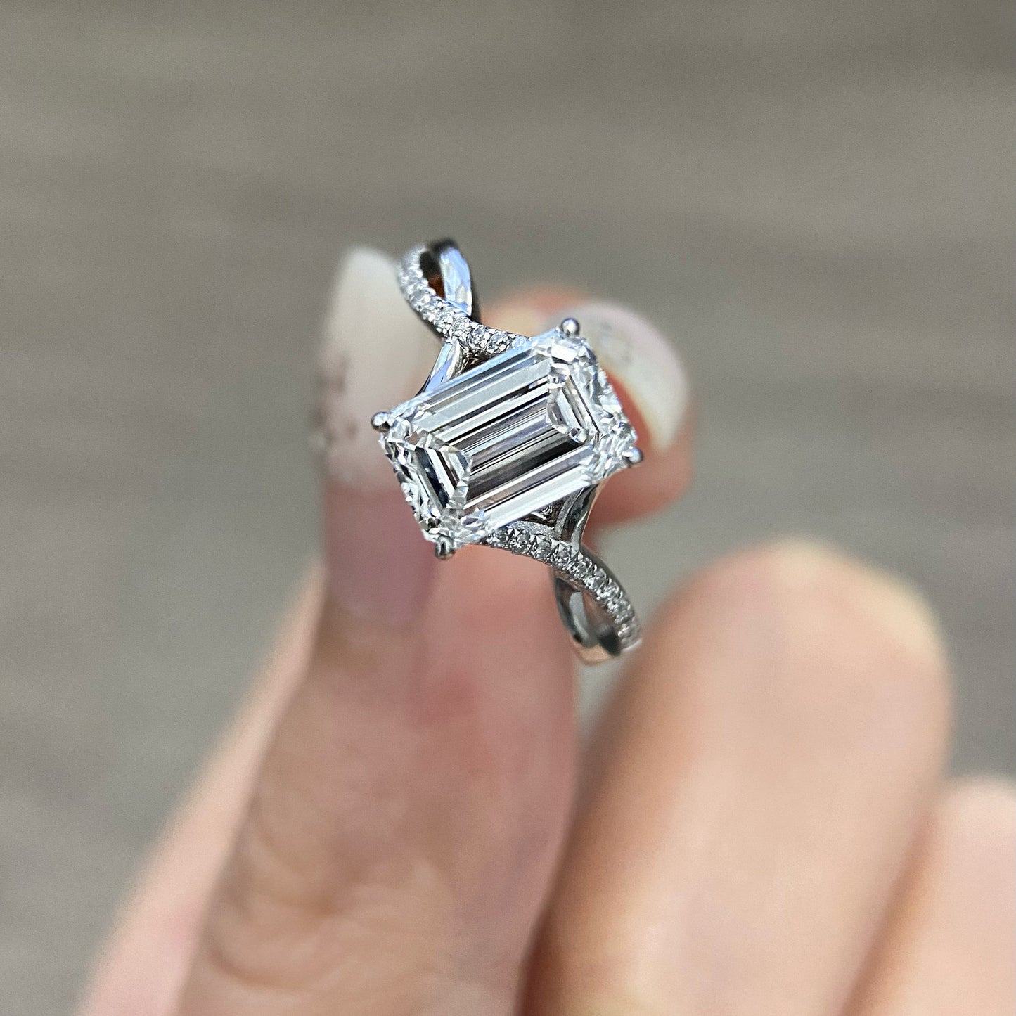 Emerald cut CVD diamond twisted style engagement ring