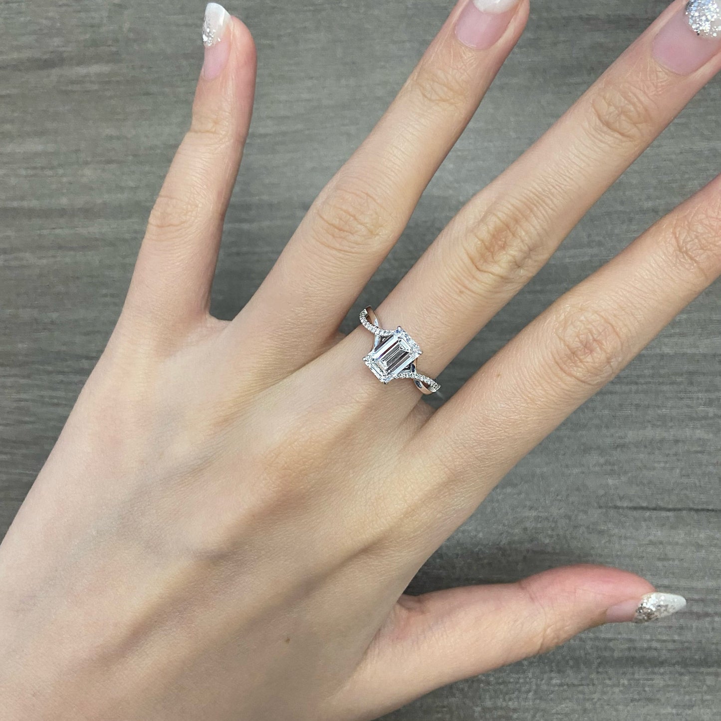 Emerald cut CVD diamond twisted style engagement ring