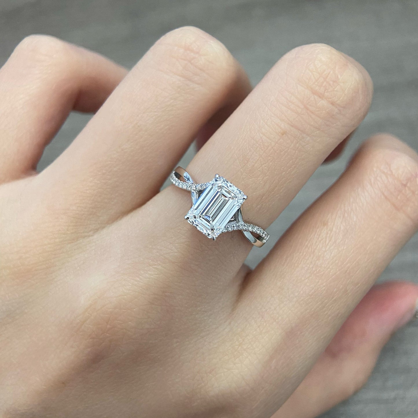 Emerald cut CVD diamond twisted style engagement ring