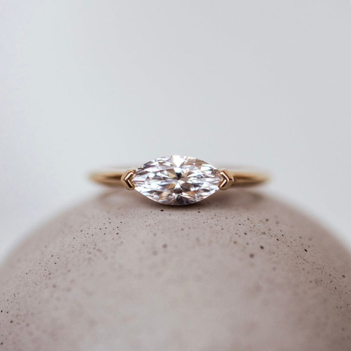 East-west solitaire engagement ring with marquise cut moissanite