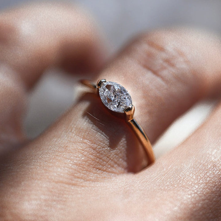 East-west solitaire engagement ring with marquise cut moissanite