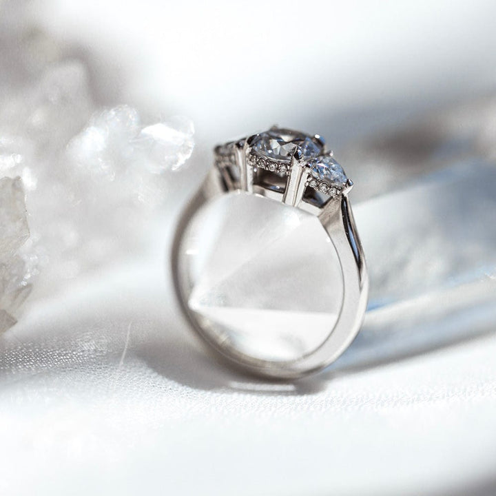 Three stone round moissanite engagement ring