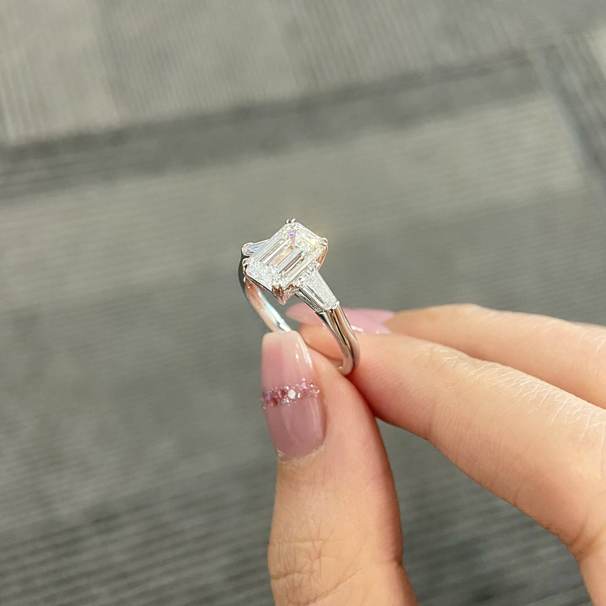 Emerald cut CVD diamond three stone engagement ring
