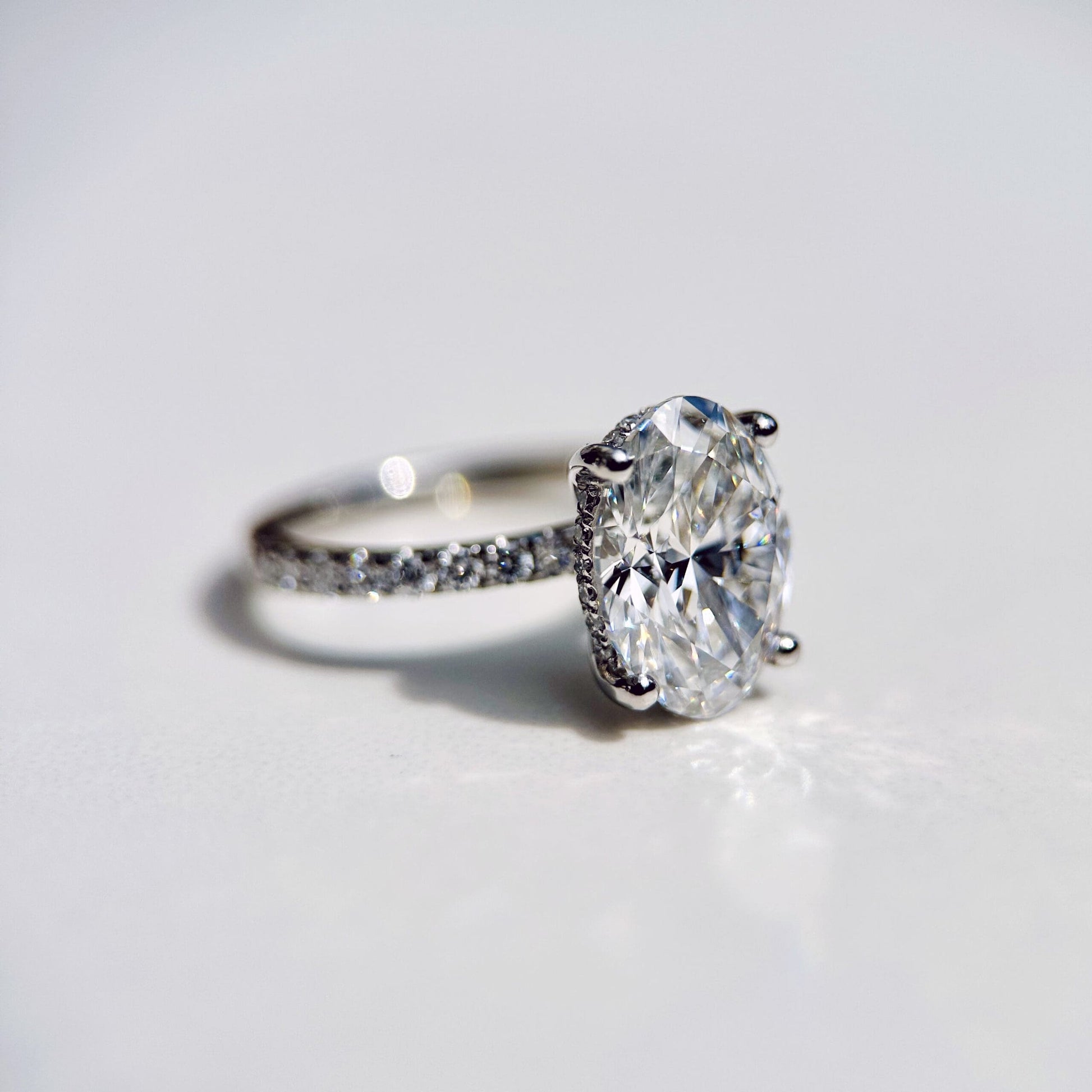 1.80 CT oval cut CVD lab grown diamond engagement ring with hidden halo, pave-set band, E color, VS1 clarity, in white gold setting