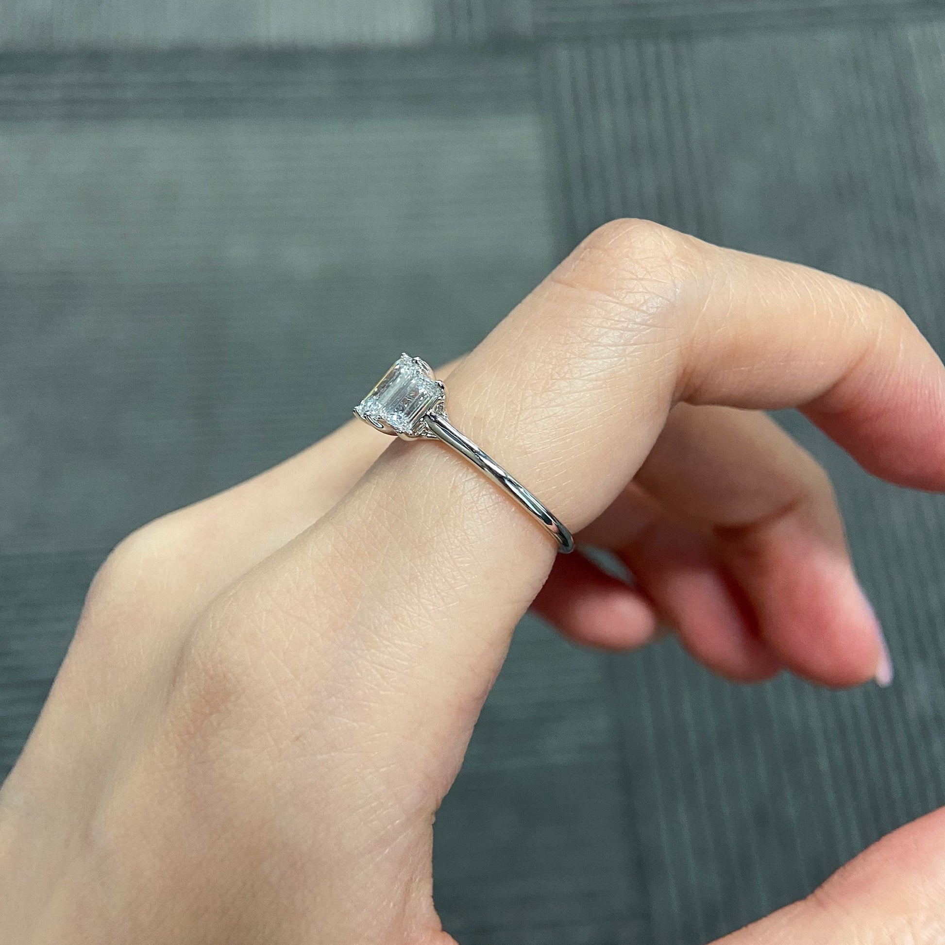 Emerald cut CVD diamond three stone engagement ring