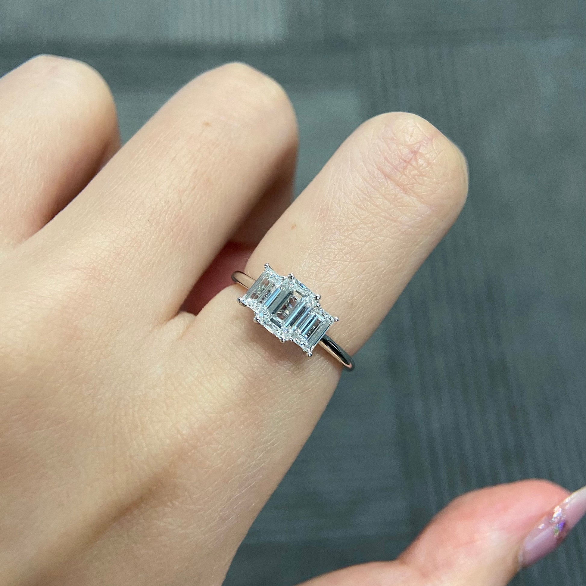 Emerald cut CVD diamond three stone engagement ring