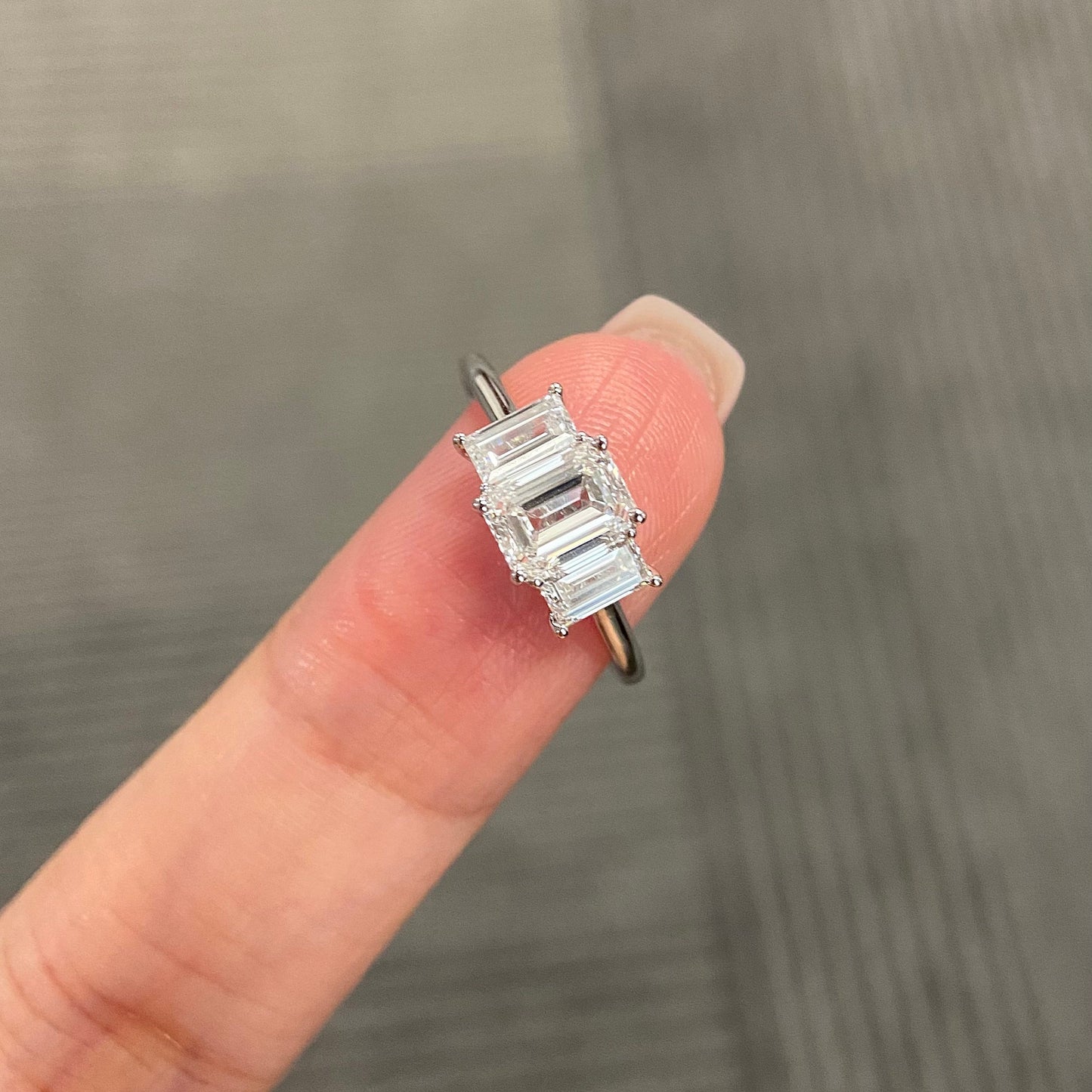 Emerald cut CVD diamond three stone engagement ring