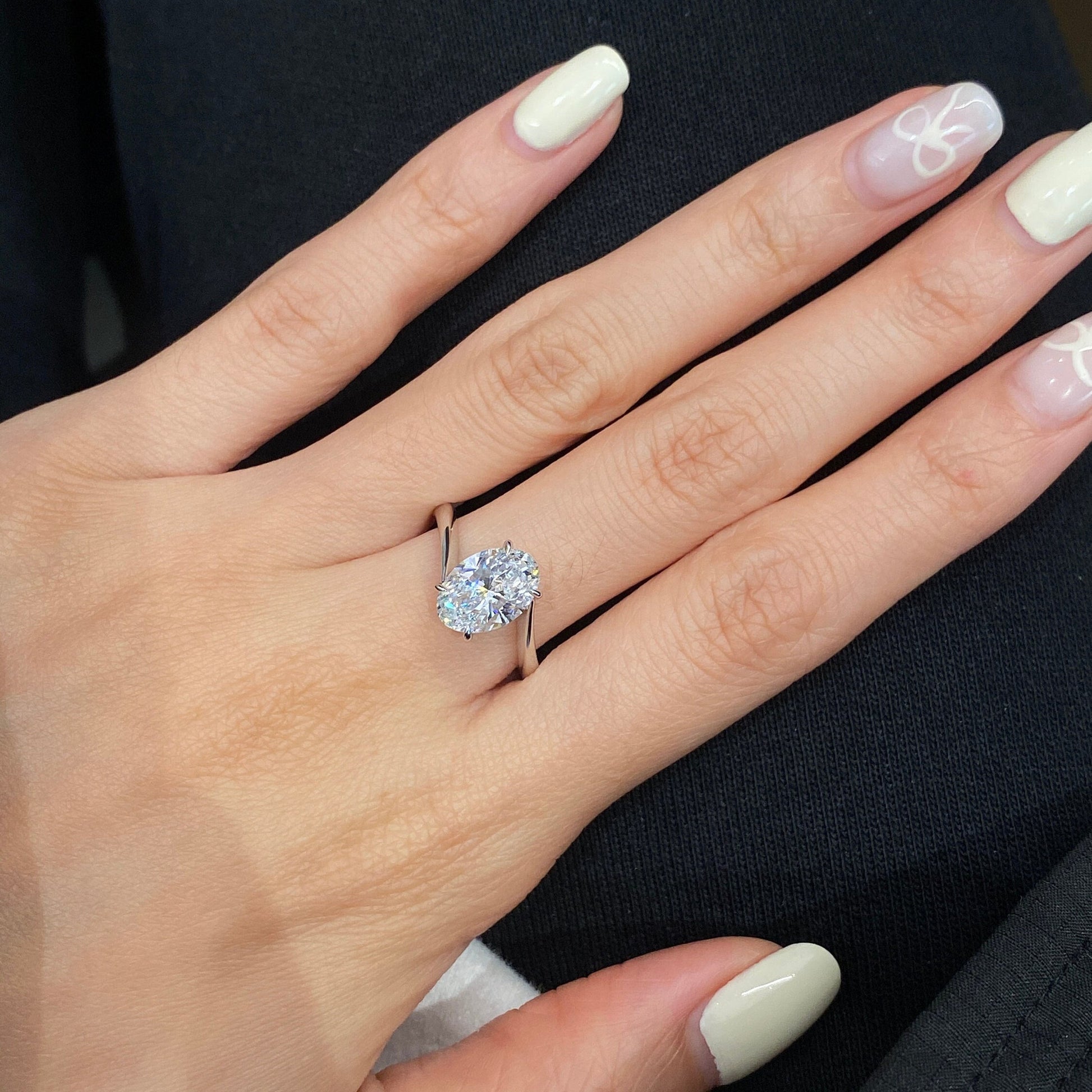 Oval cut CVD diamond bypass engagement ring with unique twist band