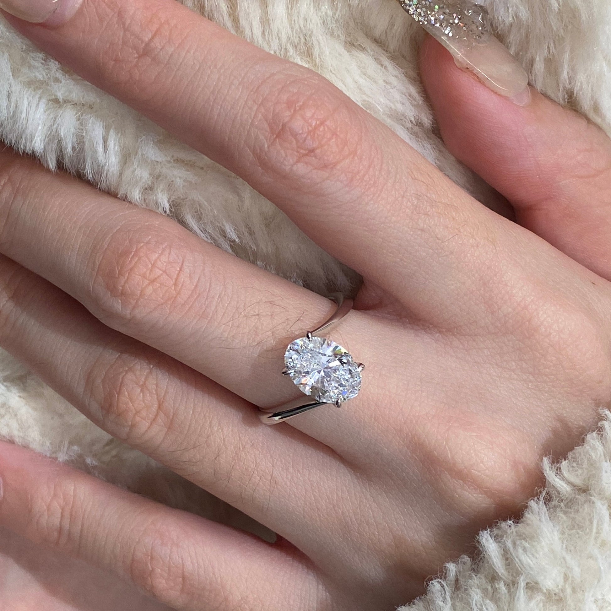 Oval cut CVD diamond bypass engagement ring with unique twist band