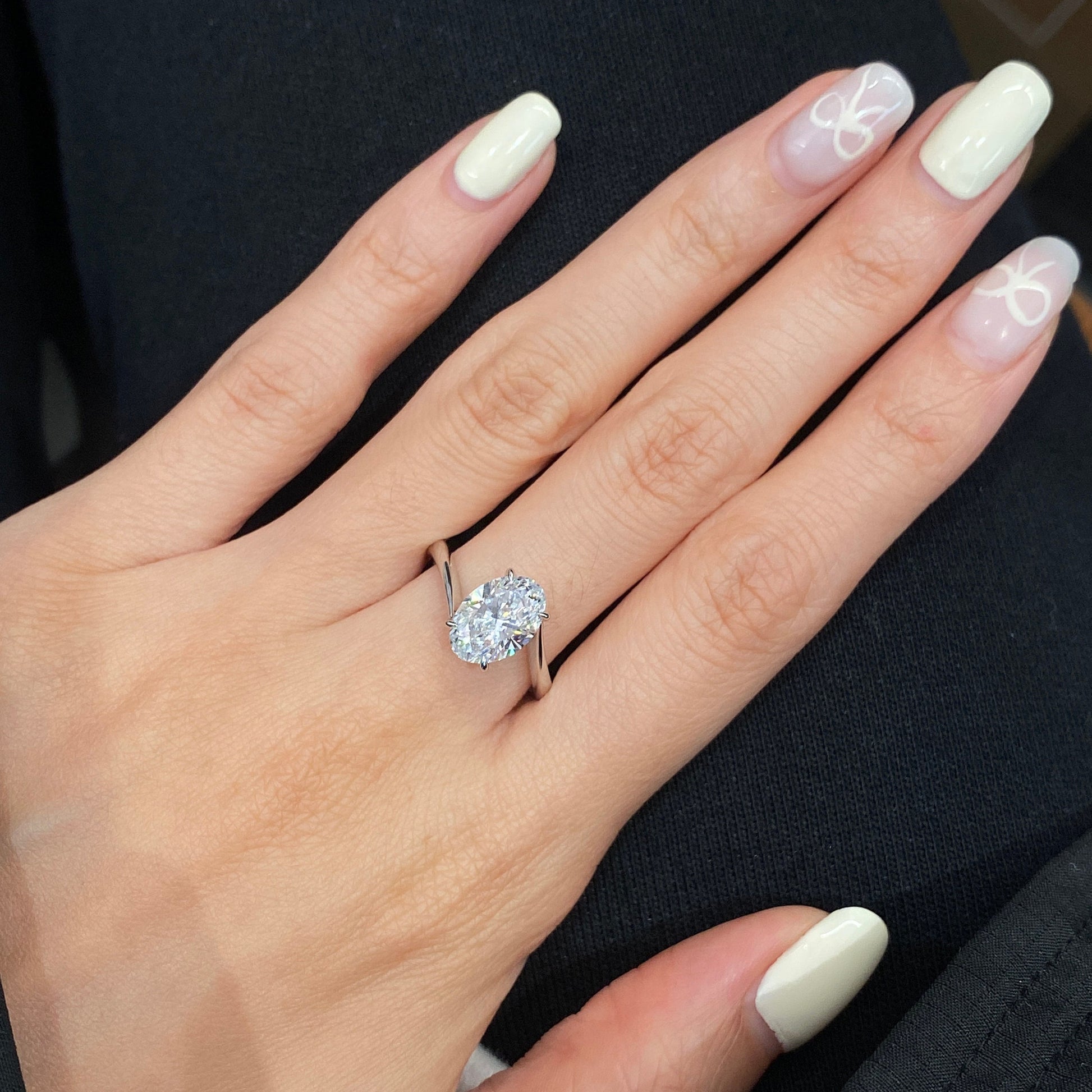 Oval cut CVD diamond bypass engagement ring with unique twist band