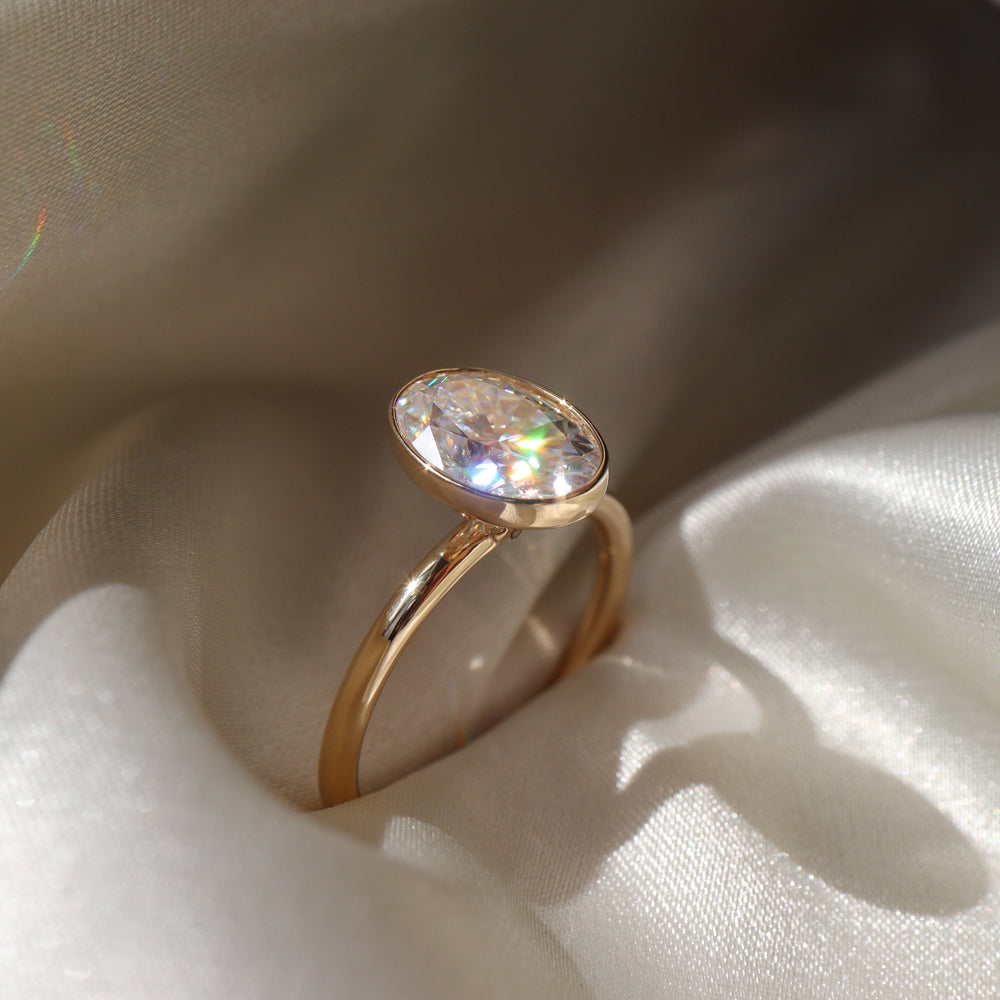 Bezel engagement ring with oval moissanite center stone