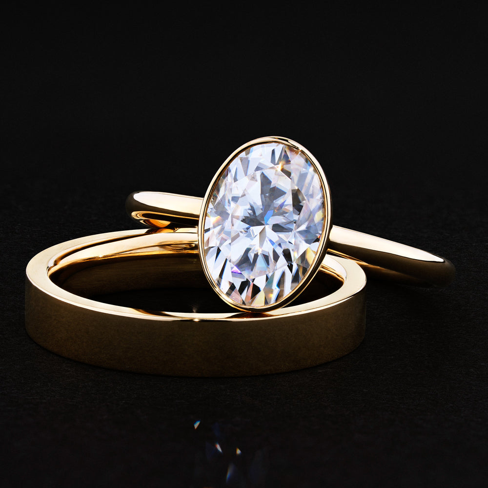 Bezel engagement ring with oval moissanite center stone