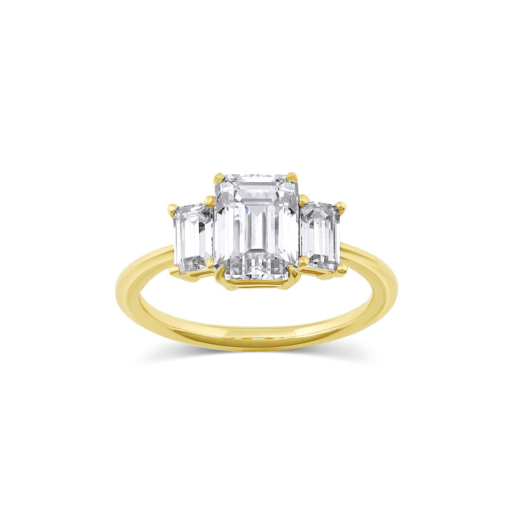 Three stone engagement ring with emerald cut moissanite center