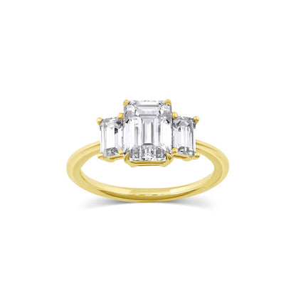 Three stone engagement ring with emerald cut moissanite center