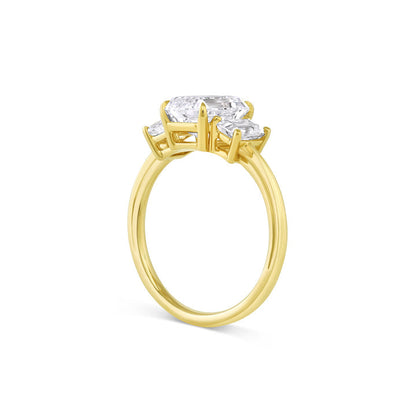 Three stone engagement ring with emerald cut moissanite center