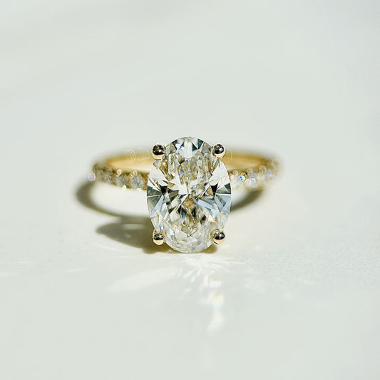 Oval cut CVD lab grown diamond engagement ring with hidden halo and pave band for refined brilliance
