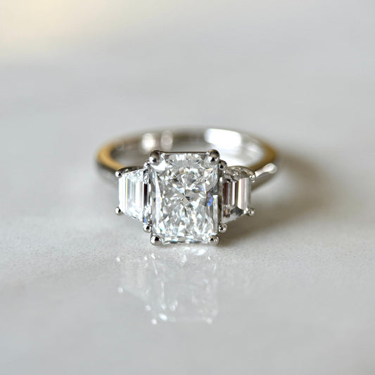 1.80 CT radiant cut CVD lab grown diamond three stone engagement ring with E color, VS1 clarity, in classic white gold prong setting