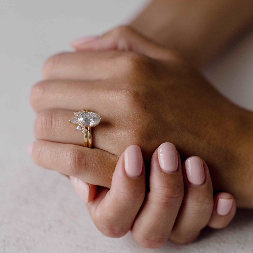 Bezel engagement ring with oval moissanite center stone