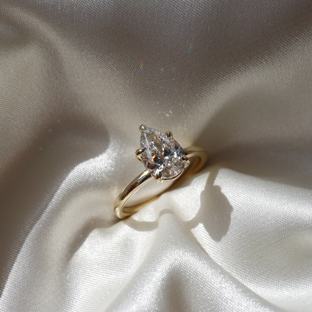 Elegant solitaire ring with pear-shaped moissanite center stone