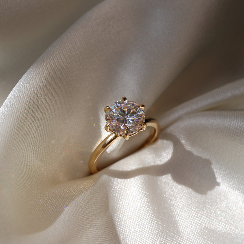 Classic solitaire ring with round moissanite center stone