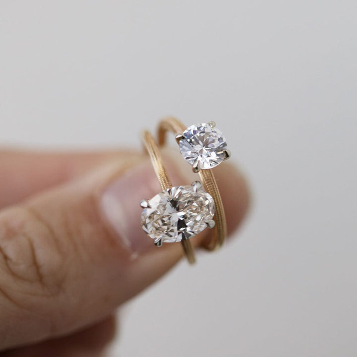 Round moissanite solitaire engagement ring with elegant band